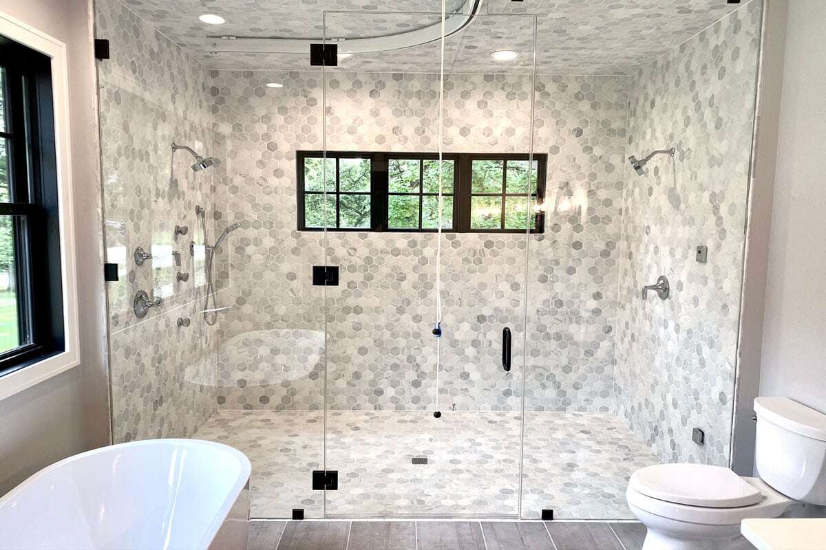 Porcelain tiles installed direct around windows in a custom, extra-large shower