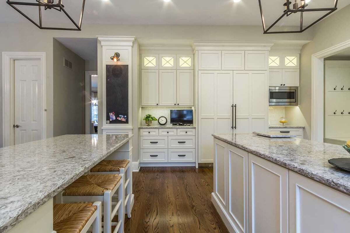 A compact kitchen desk at counter height with a monitor to watch TV. 