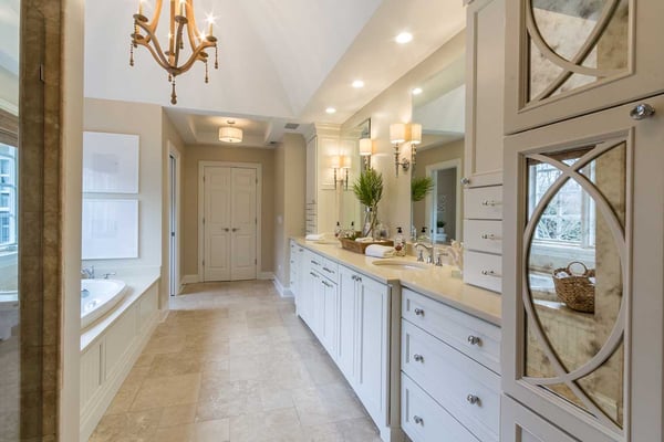 Luxury bathroom with layered lighting and natural light filling the space for a relaxing respite