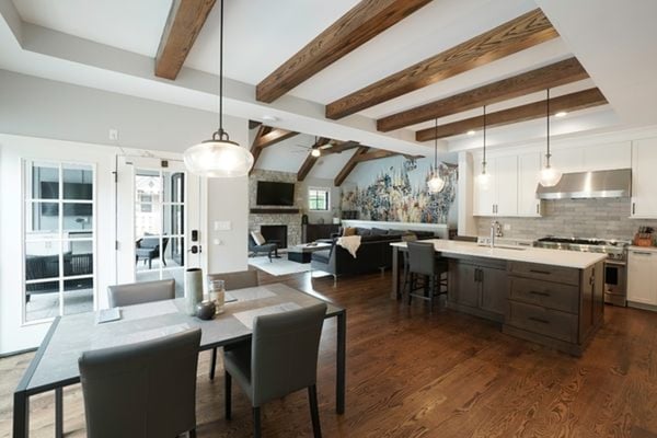 Cool and collected open kitchen plan with exposed joists in the ceiling for a rustic appeal. The natural light makes this space perfect for the summer and hot weather.