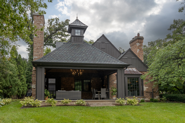 2 story home addition with a screened in porch as an extension on the home's foundation