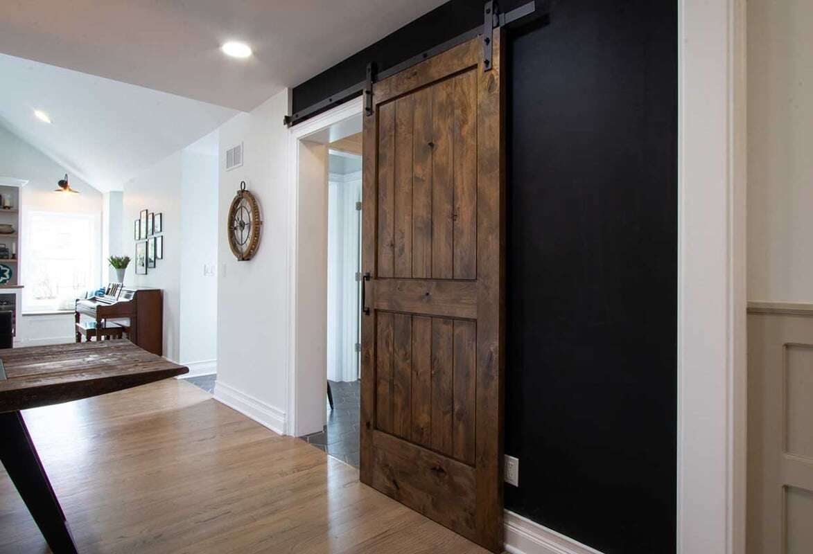 Non traditional sliding barn door entry way to a bathroom