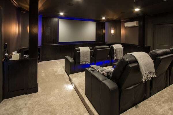 Basement Home Theatre with Leather Chairs and a Projector Screen against the far wall