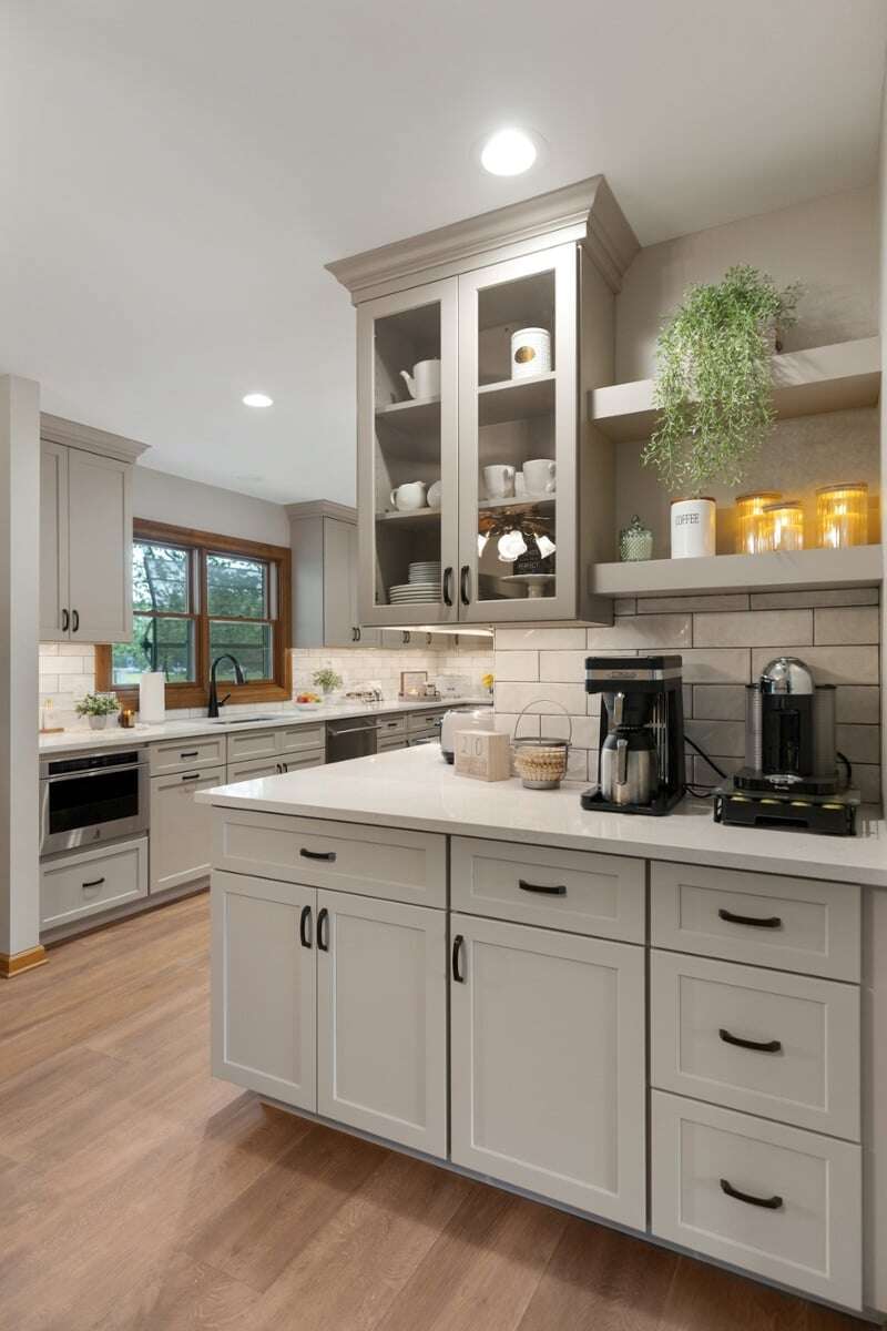 Kitchen coffee bar with a cabinet that has glass pane doors