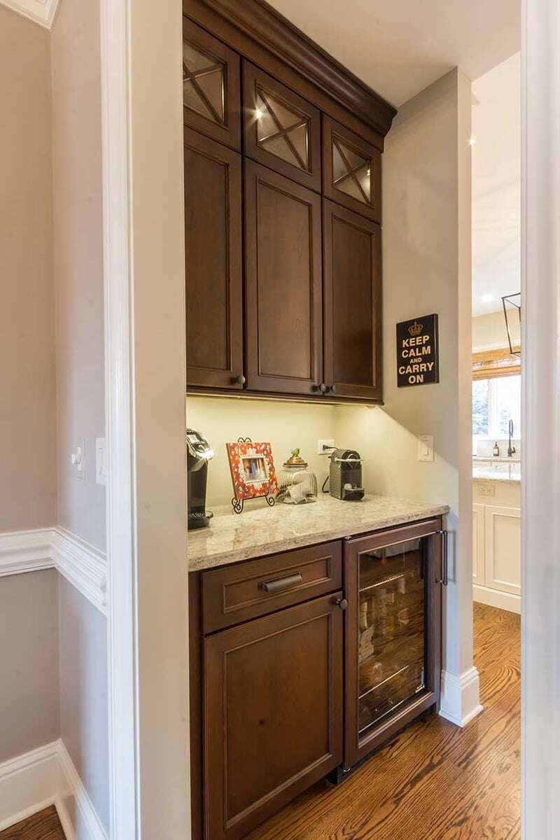 Butler's pantry with a small coffee bar and mini fridge mounted below