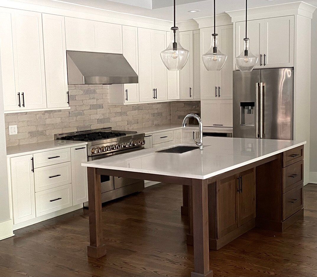 Elegant kitchen island with lots of leg room and some added storage space below the granite countertop