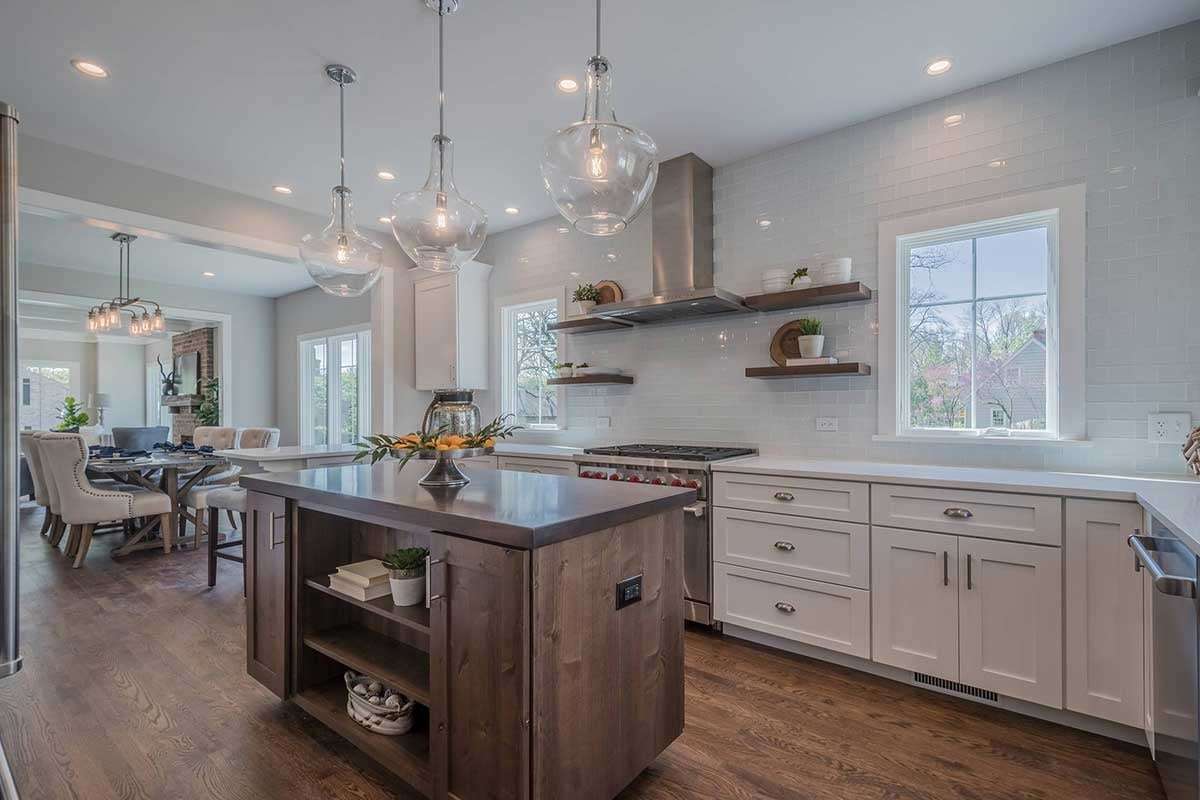 Elegant kitchen remodel with a stove that has red burner knobs