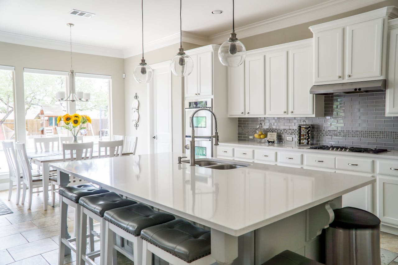 Beautiful kitchen island underneath glass hanging lights