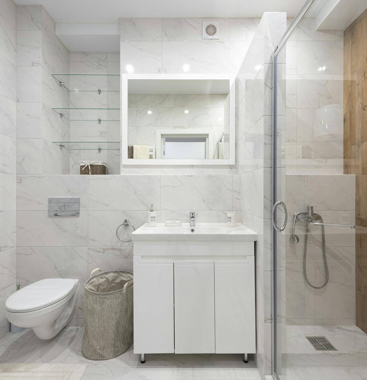 bathroom with organization features like shelving, a laundry basket, and more